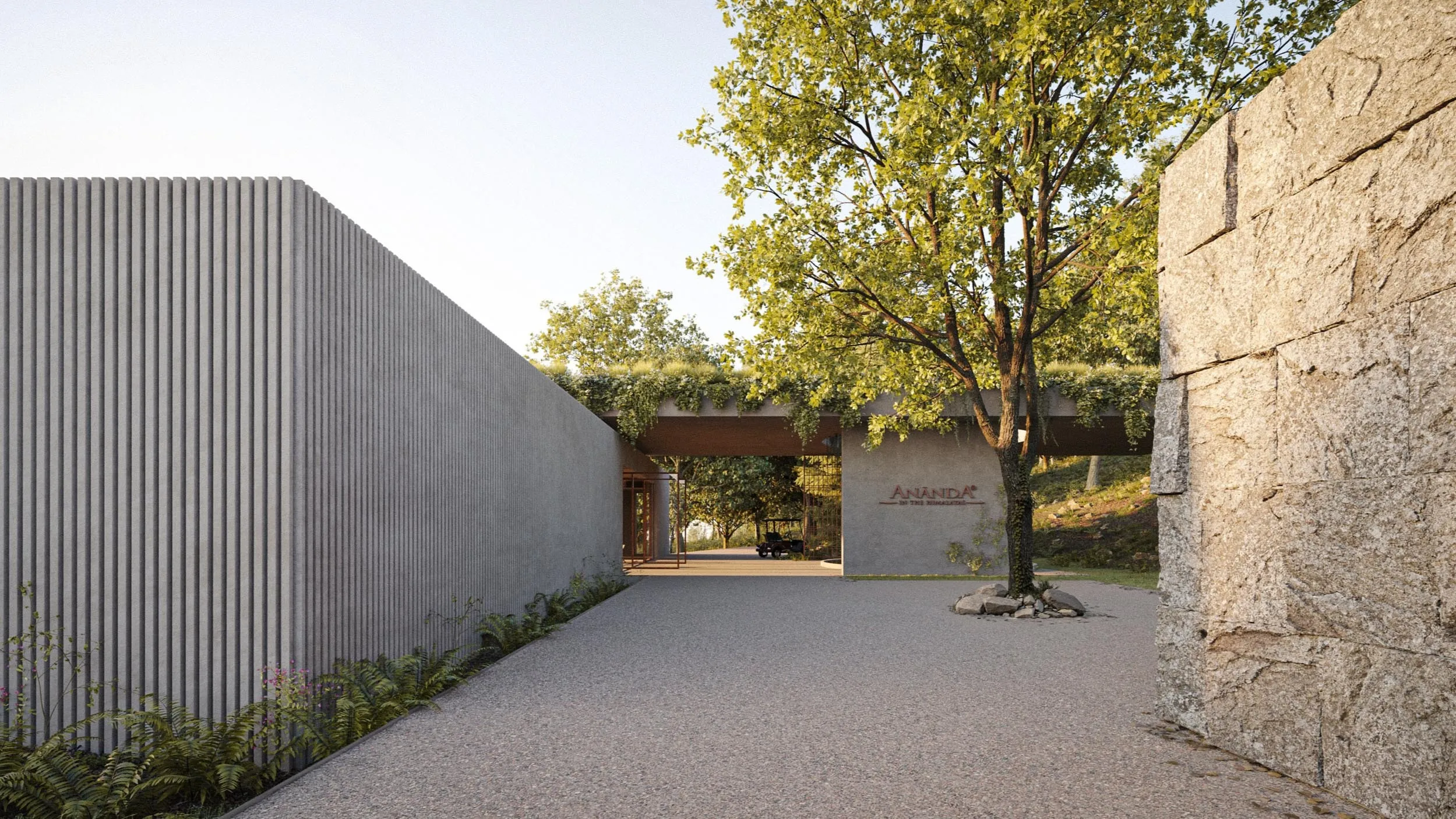 Stone walls and a tree in the gravel courtyard