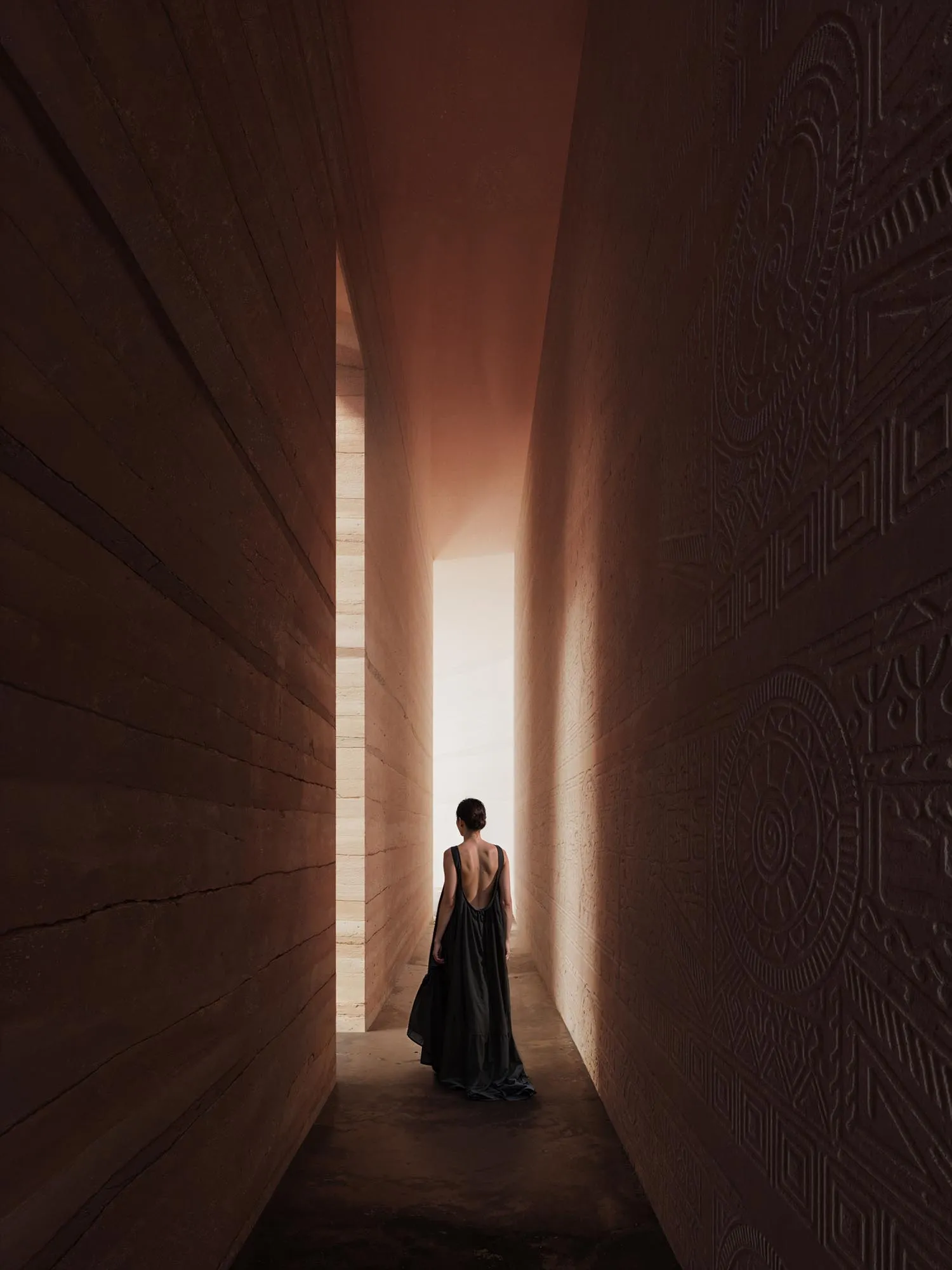 A figure in the slit of light, the corridor