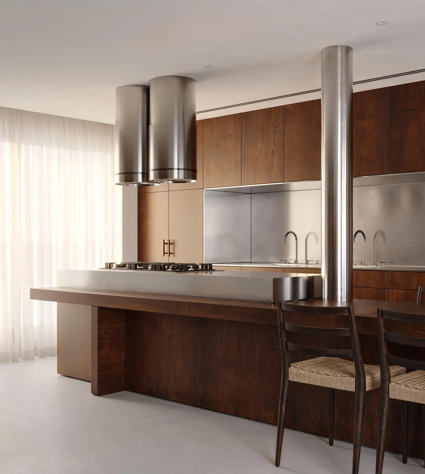 Kitchen with a steel hood and a wooden island
